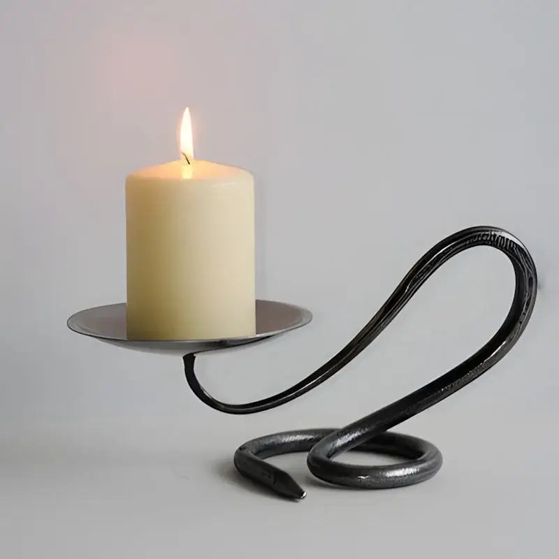 Black wrought iron candlestick holder with curved twisted design holding off white pillar candle for decorbites golden banana decor