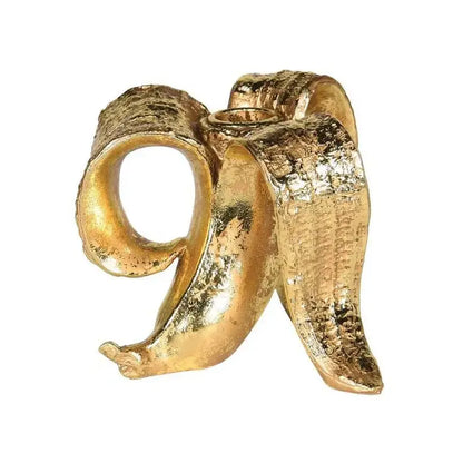 Golden banana candlestick holder with textured metallic finish and detailed peel for dining room decor by decorbites