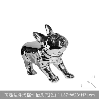 Shiny silver french bulldog figurine with glossy surface and stylized design beside black and gold banana candlestick holder decorbites golden banana decor