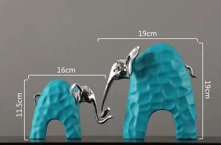 A pair of turquoise and silver decorbites elephant figurines with textured geometric surfaces as golden resin sculpture