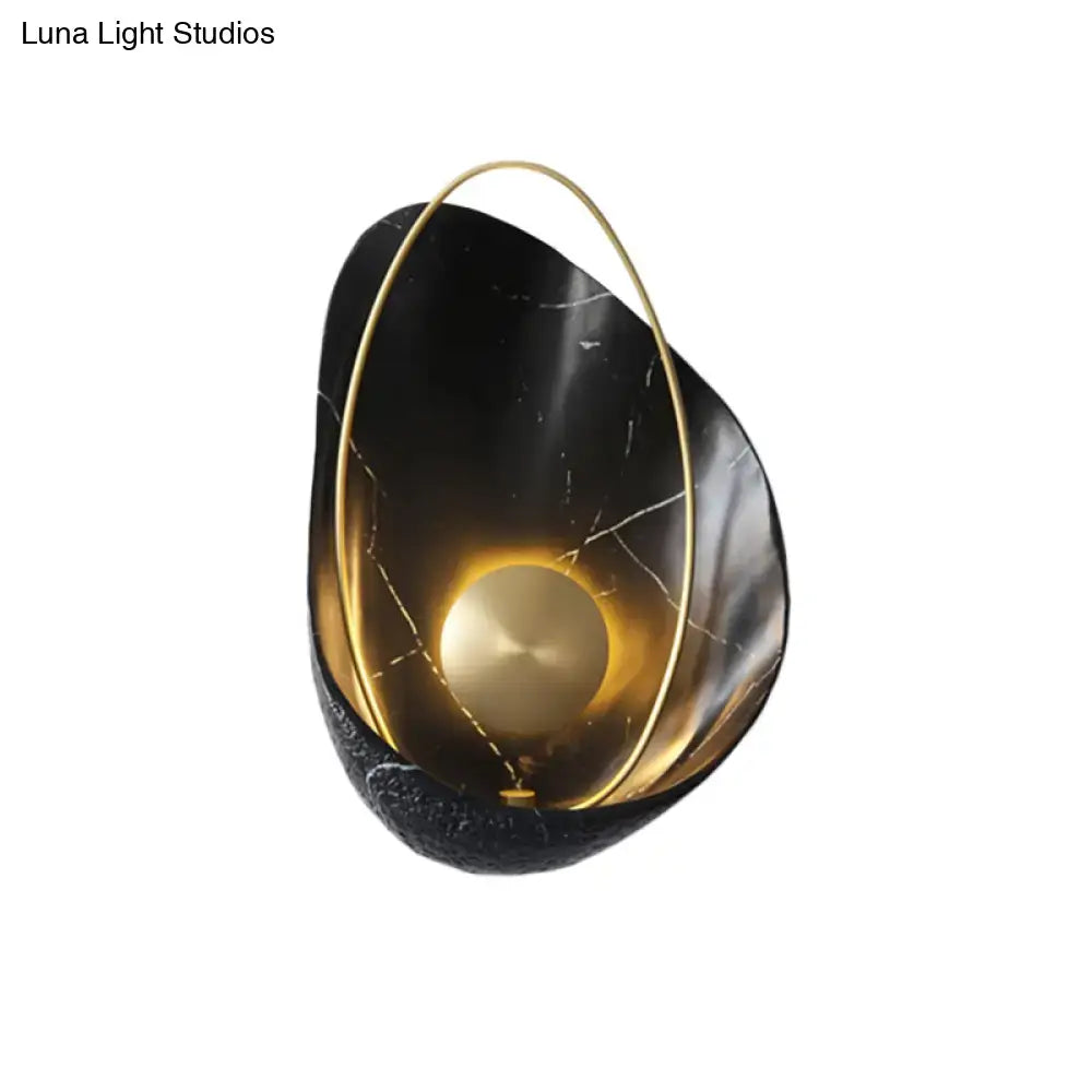 Black and gold marble wall light with a circular frame and maximum bulb wattage of 40w for living room use