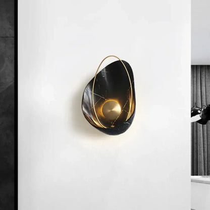 Black and gold marble wall light featuring a circular fixture with gold-toned metal accents and 40w maximum bulb wattage