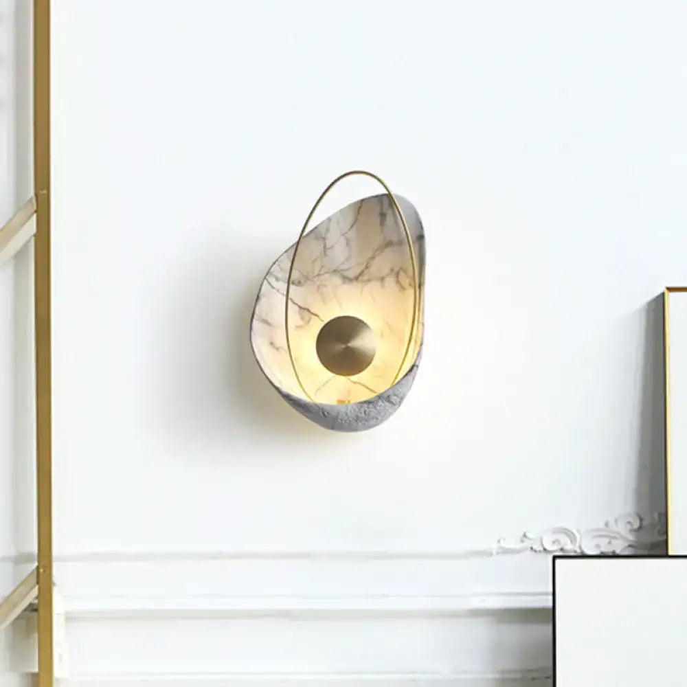 Modern wall light with beige gray marble-like body and gold frame supporting maximum bulb wattage 40w for living room use