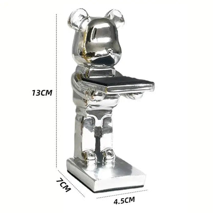 Silver metallic bear watch stand holding a black tray for black and iridescent purple cartoon bear bedroom decor