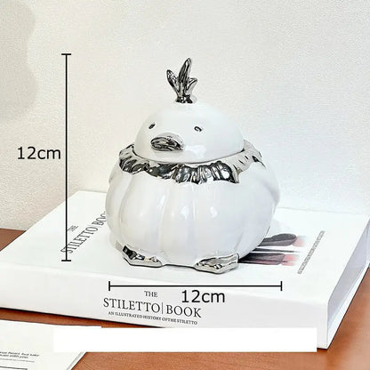 White ceramic garlic duck decorative jar with silver accents on beak scarf and feet for decorbites garlic duck collection