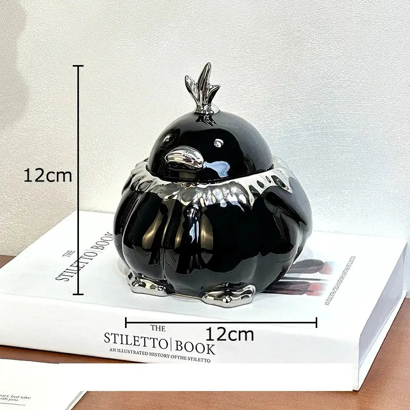 Black glossy ceramic garlic duck jar with silver metallic beak feet and crown decorbites garlic duck decor
