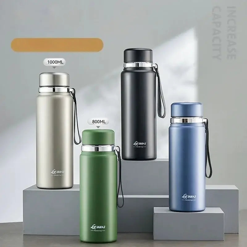 Three insulated stainless steel 24hr cold cups in silver black and blue with matching lids and wrist straps for travel