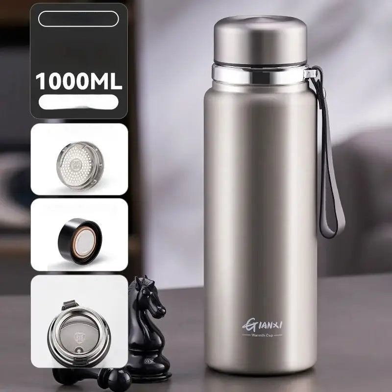 A sleek black and silver stainless steel 1000ml 24hr cold cup insulated water bottle with a silver lid and black strap