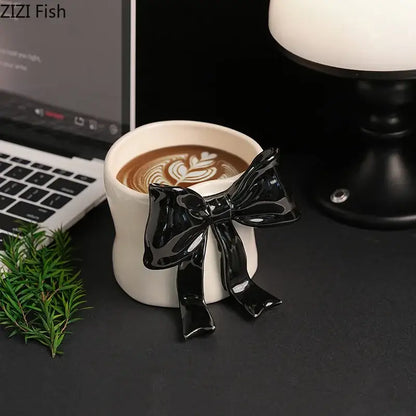 White porcelain coffee cup with glossy black bowknot designed for dining room and everyday coffee use