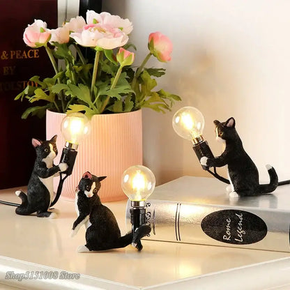 Black and white cat resin table lamp featuring three figurines holding glowing bulbs for bedroom decorbites cat resin use