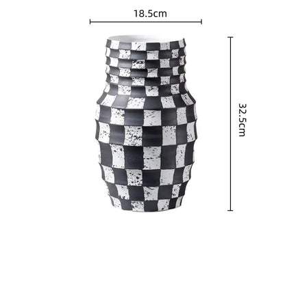 A black and white check geometric ceramic vase with a sleek textured pattern for living room floral decor