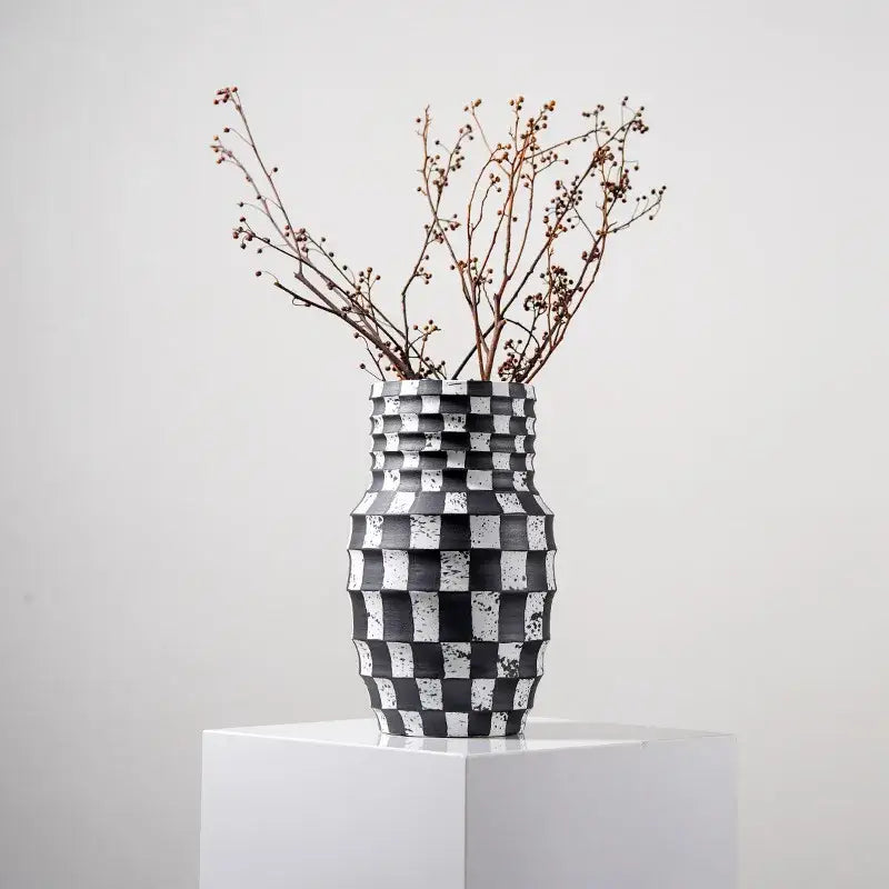 A sleek black and white check geometric ceramic vase with textured pattern for living room floral pot use
