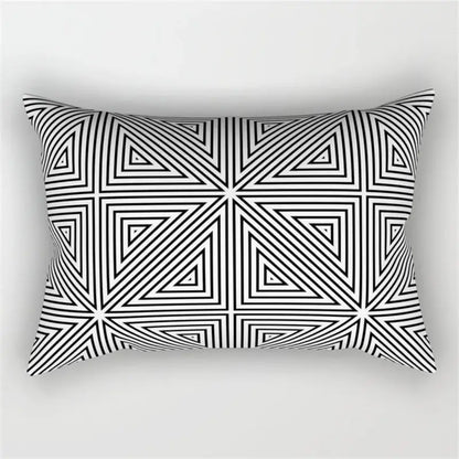 Rectangular pillow with a bold black and white geometric wave line pattern of interlocking triangles for bedroom decor