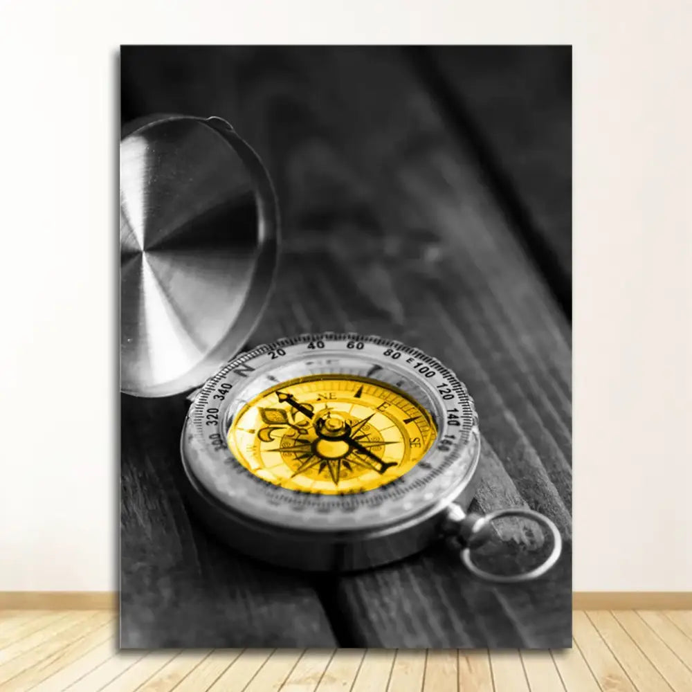 A metallic compass with a yellow face and silver casing complements the decorbites™ black and white nordic landscape canvas set
