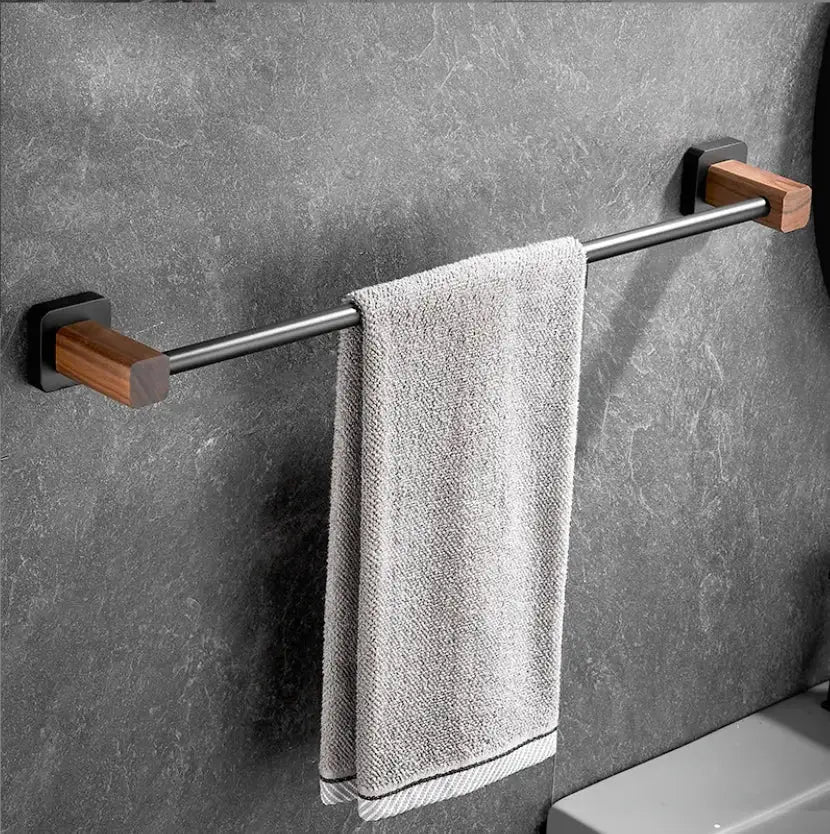 Black and wood bathroom hardware set with storage shelf features a sleek metal bar and wooden end caps with a gray towel decorbites bathroom hardware