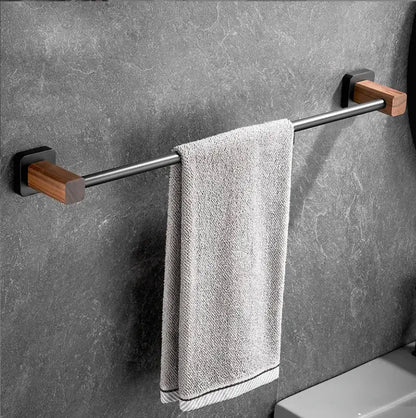 Black and wood bathroom hardware set with storage shelf features a sleek metal bar and wooden end caps with a gray towel decorbites bathroom hardware
