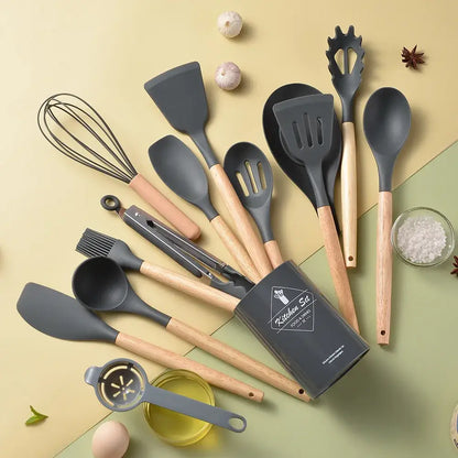 Set of gray silicone kitchen utensils with wooden handles in a black storage box kitchen utensil set