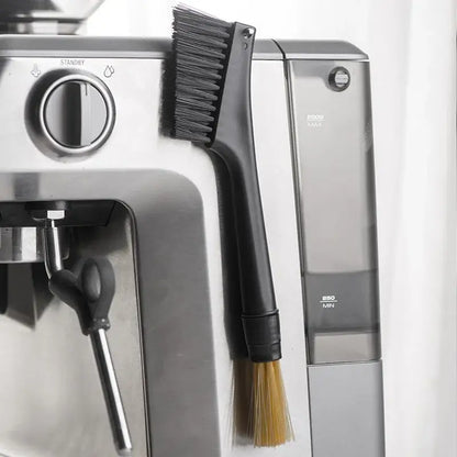 Black and yellow dual head coffee grinder brush with dense dark and lighter tan bristles for cleaning espresso machines