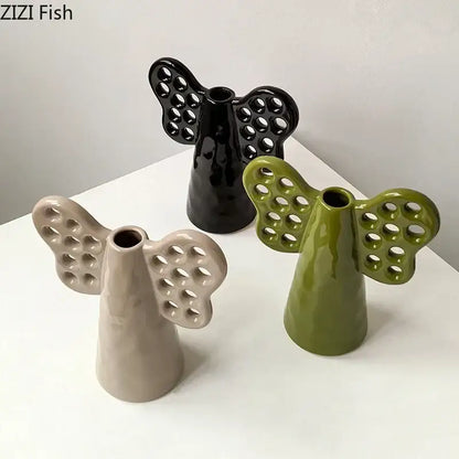 Black olive green and beige ceramic angel vases with perforated wings featuring artificial flowers decorbites elephant ceramic vase