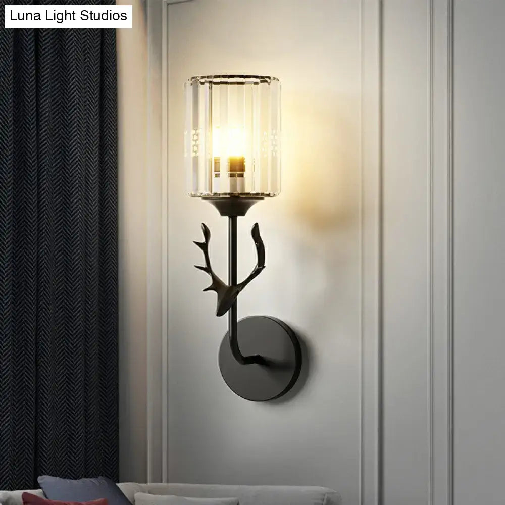 Black metal wall sconce with antler design and clear glass cylinder shade compatible with e26 e27 bulbs for bedroom use