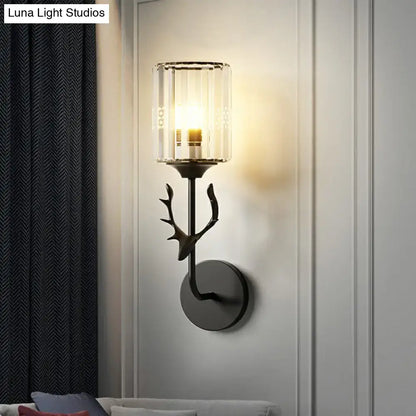 Black metal wall sconce with antler design and clear glass cylinder shade compatible with e26 e27 bulbs for bedroom use