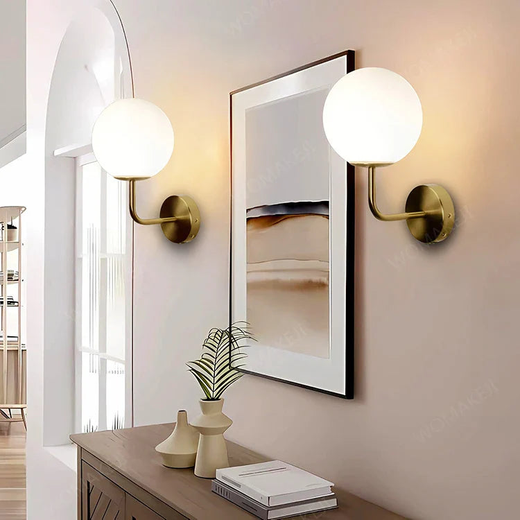 Illuminated globe sconces.
