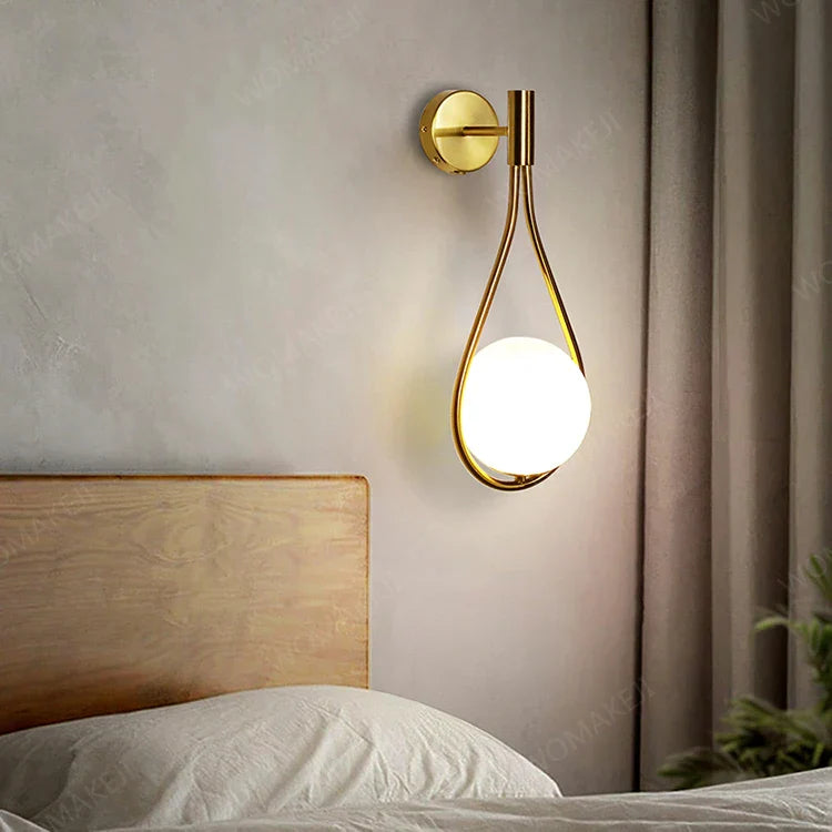Gold teardrop wall sconce.