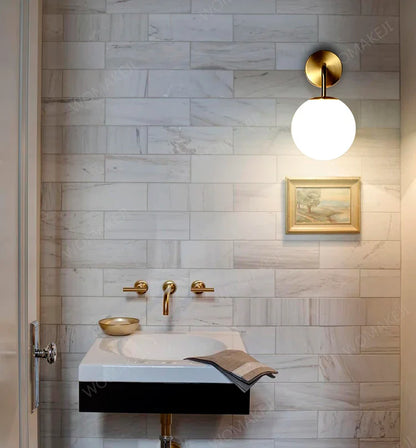 Bathroom sink with gold fixtures.