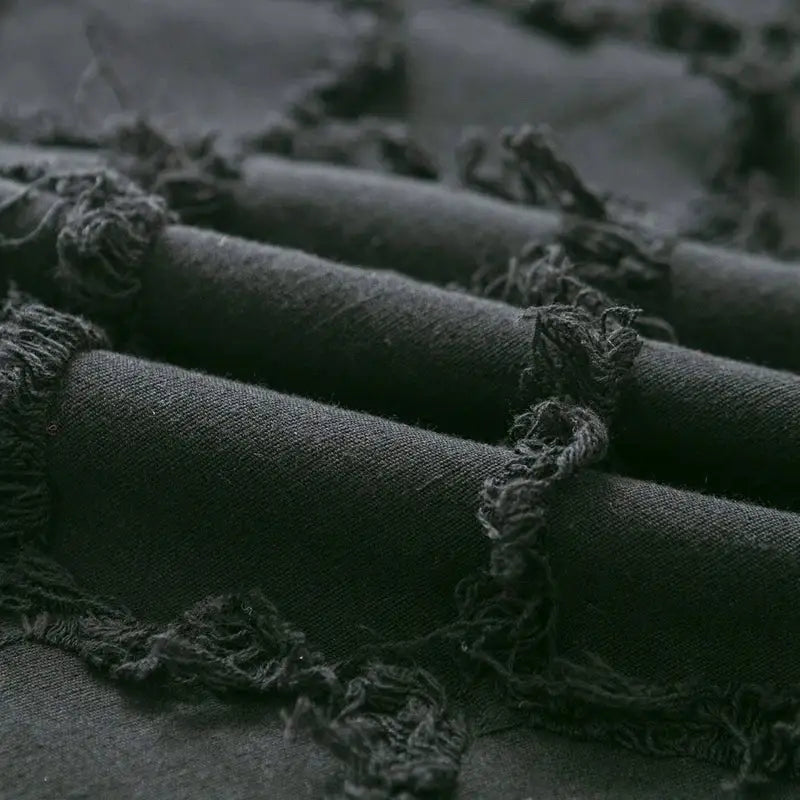 Dark gray textured fabric with frayed edges on decorbites black boho lumbar pillow cover for bedroom decor