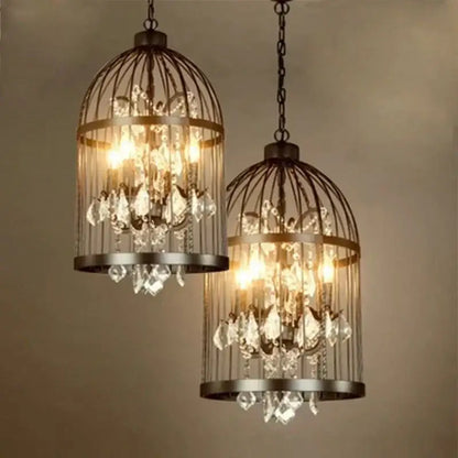 Two ornate black and bronze iron birdcage crystal chandelier pendant lights with dark metal frames and crystal droplets