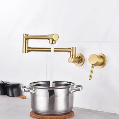 Black brushed gold kitchen pot filler wall mounted dual handle tap with gold-colored sleek articulated faucet design