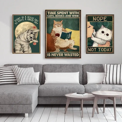 Three framed cat-themed posters featuring vintage black cat reading illustrations with humorous text above a gray sofa