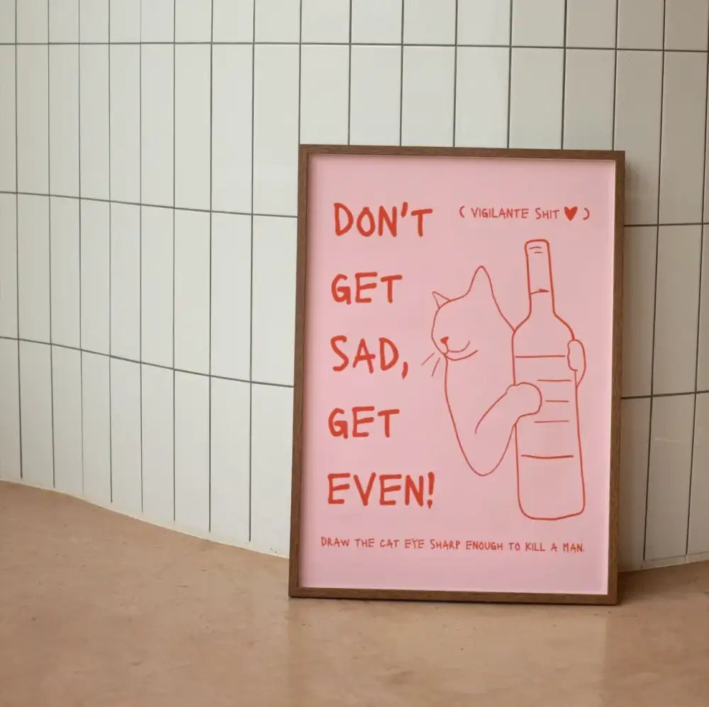 A framed pink DecorBites™ wall art canvas featuring red text and a funny black cat holding a wine bottle line drawing