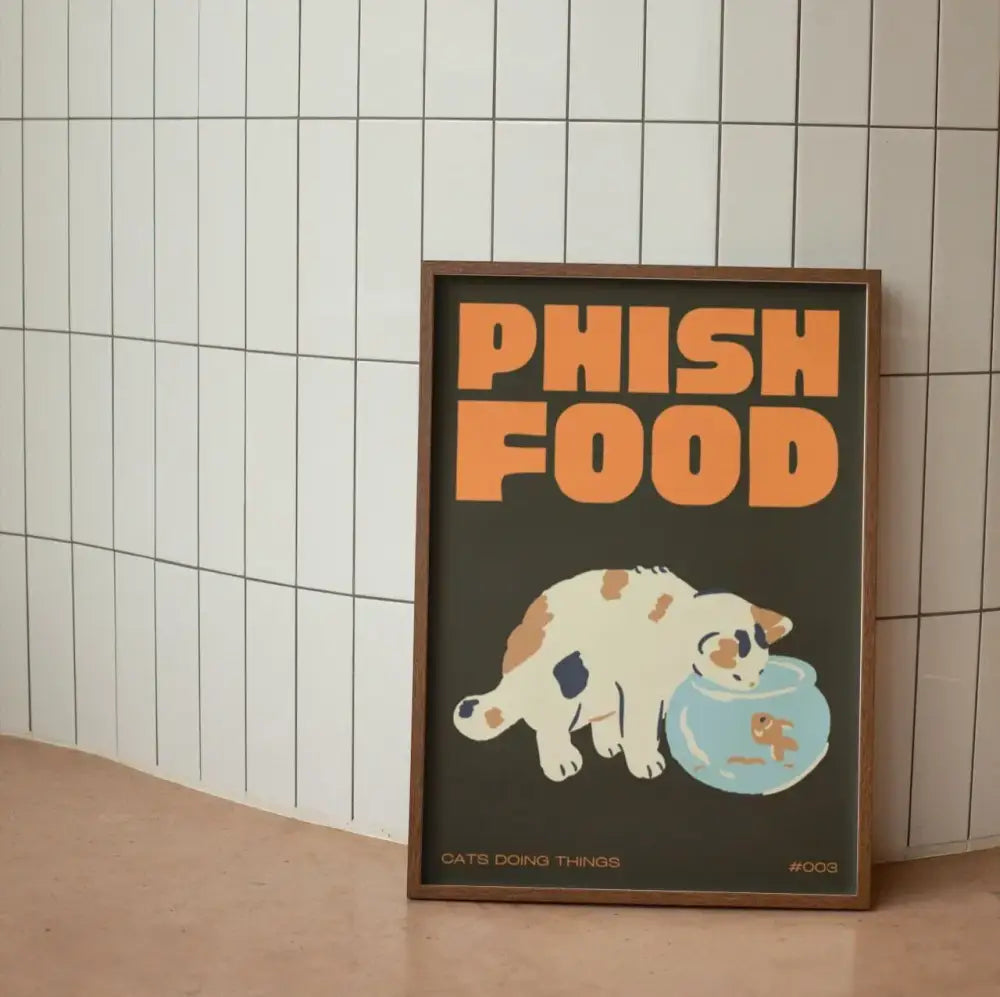 A framed DecorBites™ wall art canvas featuring a black cat cartoon with orange text and a fishbowl on dark background