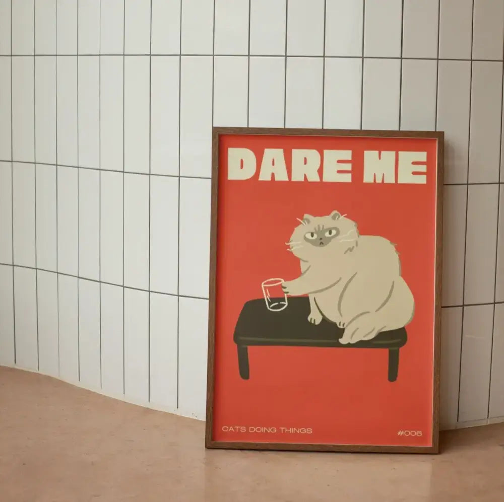 A framed decorbites™ wall art canvas with a bold red background featuring a fluffy white cat on a black bench and funny animal text dare me
