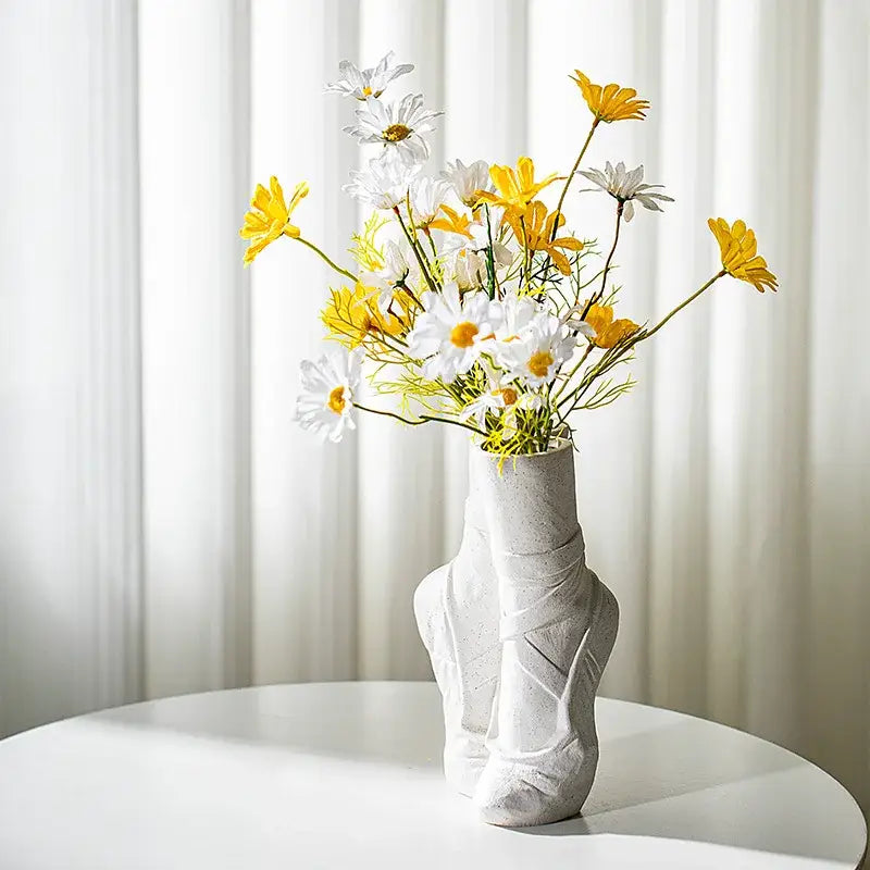 White ceramic ballet shoes vase shaped like a slipper with textured surface and gray speckles for bedroom decor