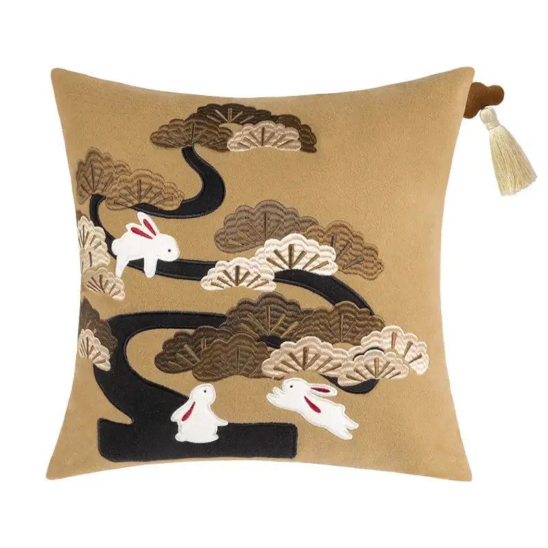 Tan velvet bolster pillow covers with embroidered white rabbits and stylized black bamboo leaves for bedroom decor