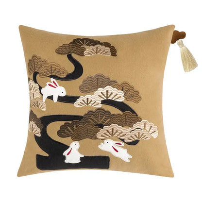 Tan velvet bolster pillow covers with embroidered white rabbits and stylized black bamboo leaves for bedroom decor