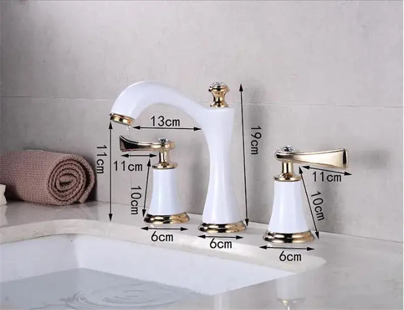 White ceramic bathroom sink faucets with gold brass accents and decorative crystal knobs for elegant bathroom use