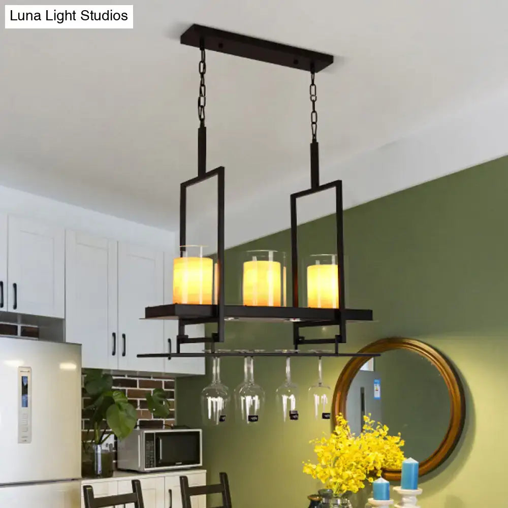 Black metal island light fixture with three glowing candle lights, clear glass cylindrical pendants, and wine glass rack