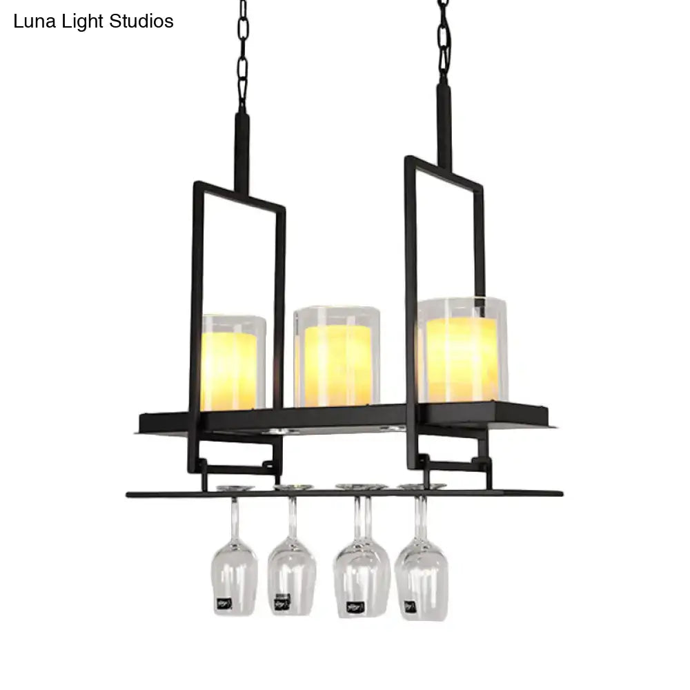 DecorBites black metal island light fixture with three glowing candle-style lights and clear glass cylindrical pendants