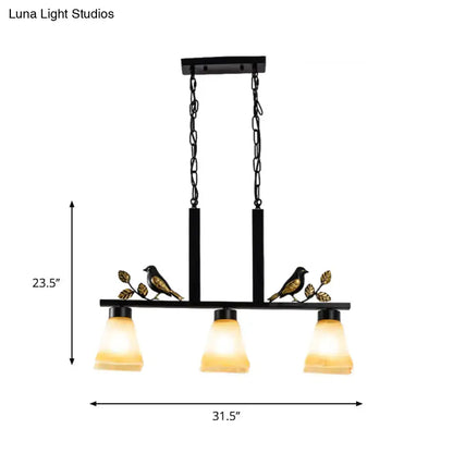 DecorBites black island light pendant with three tan glass shades and gold bird decor for traditional dining room