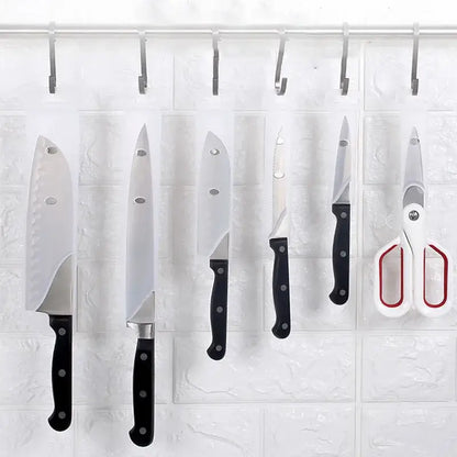 Set of black decorbites knife scabbard with five kitchen knives scissors and hooks hanging on black handles