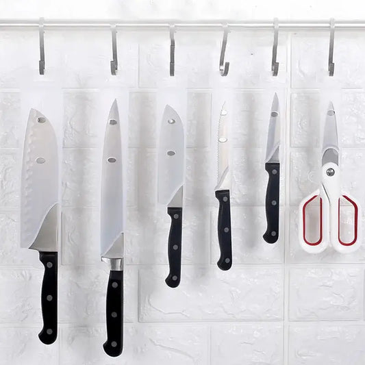 Set of black decorbites knife scabbard with five kitchen knives scissors and hooks hanging on black handles