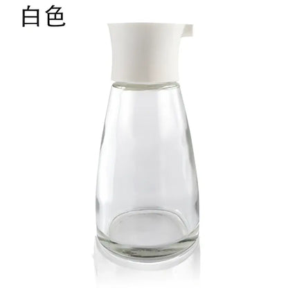 Clear glass 170ml seasoning bottle with white plastic spout and lid from black and lime green kitchen set