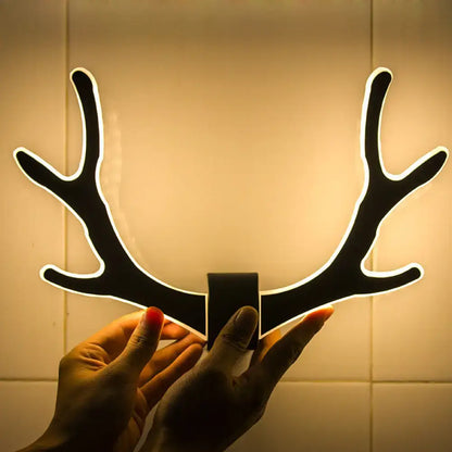 Black metallic antler sconce wall mounted lighting with glowing white outline for bedroom mounted lighting fixture