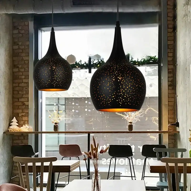 Black nordic industrial pendant light with speckled starry pattern and warm amber glow for dining room decorbites