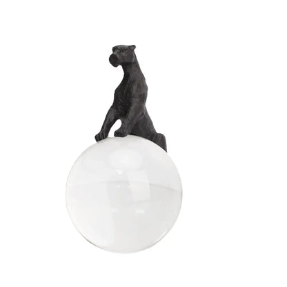 Black matte-finished panther figurine perched on clear glass sphere crystal ball metal animal decorbites living room decor