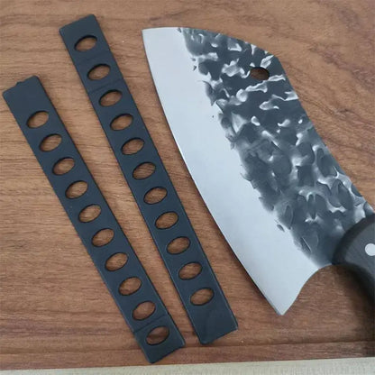 Black plastic knife blade protectors set with oval holes beside a hammered steel chef knife with dark handle for kitchen use