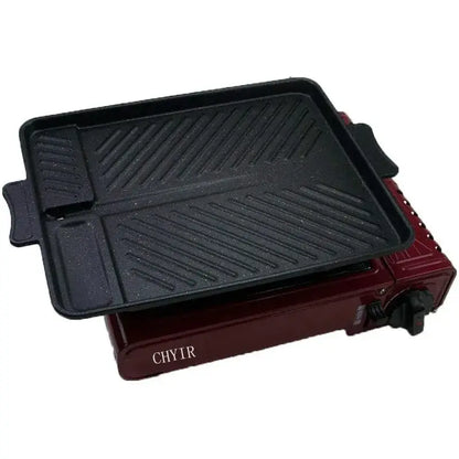 Black rectangular non stick korean grill pan with diagonal ridges on red portable gas burner decorbites korean grill